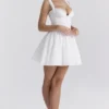 Brigitte Biała bawełniana mini sukienka z gorsetem w stylu broderie anglaise Brigitte Biała bawełniana mini sukienka z gorsetem w stylu broderie anglaise